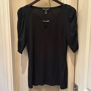 Black top with three-quarter length sleeves.